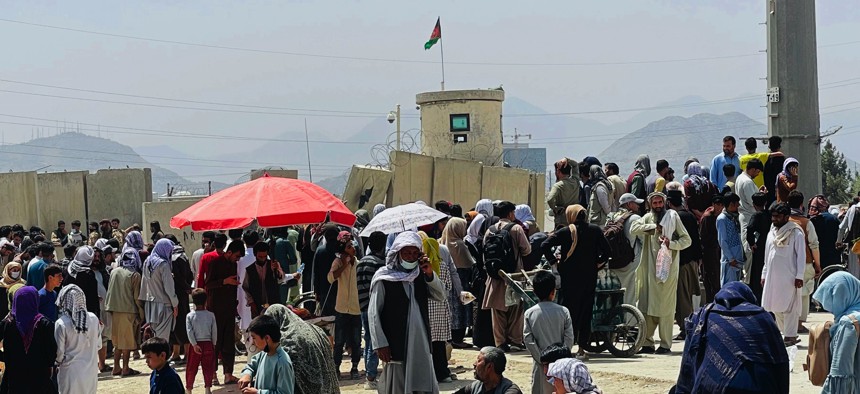 Hundreds of people gather outside the international airport in Kabul, Afghanistan, on Aug. 17, 2021.