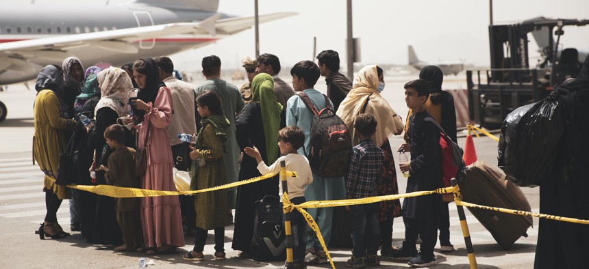 Civilians prepare to board a plane during an evacuation at Hamid Karzai International Airport, Kabul, Afghanistan, Aug. 18.