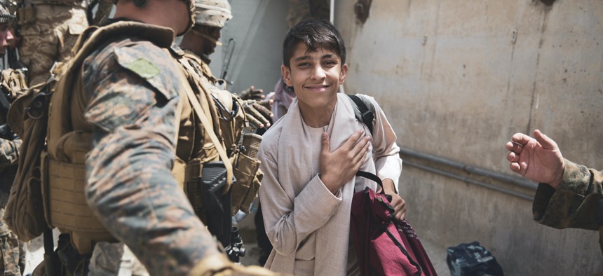 A boy is processed through an evacuee control checkpoint during an evacuation at Hamid Karzai International Airport, Kabul, Afghanistan, Aug. 18. 