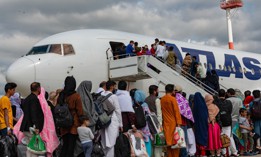 Evacuees board an Atlas Air aircraft for a departure flight from Ramstein Air Base, Germany, on their way to the United States as part of Operations Allies Refuge, Aug. 24, 2021.