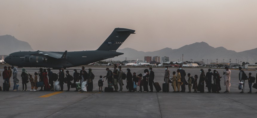 Evacuees wait to board a Boeing C-17 Globemaster III during an evacuation at Hamid Karzai International Airport, Kabul, Afghanistan, Aug. 23. 