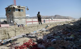 A Taliban fighter stands guard at the site of the August 26 suicide bomb attack that killed scores of people, including 13 U.S. troops, at Kabul airport on August 27, 2021. 