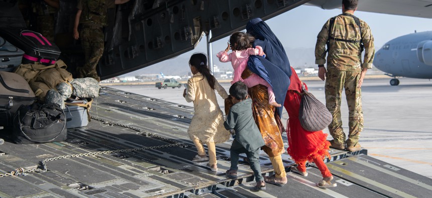 U.S. Air Force loadmasters and pilots assigned to the 816th Expeditionary Airlift Squadron load passengers aboard a U.S. Air Force C-17 Globemaster III in support of the Afghanistan evacuation at Hamid Karzai International Airport, Afghanistan, Aug. 24, 2021. 