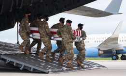 A transfer case with the remains of Army Staff Sgt. Ryan C. Knauss, 23, of Corryton, Tennessee, are carried off of a military aircraft at Dover Air Force Base in Dover, Delaware, August, 29, 2021