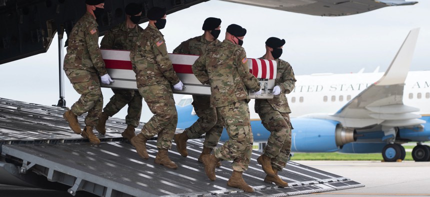 A transfer case with the remains of Army Staff Sgt. Ryan C. Knauss, 23, of Corryton, Tennessee, are carried off of a military aircraft at Dover Air Force Base in Dover, Delaware, August, 29, 2021
