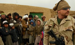 A U.S. Army Special Forces soldier is surrounded by a curious crowd of Afghan onlookers in a remote village in the mountains of western Afghanistan in 2002. 