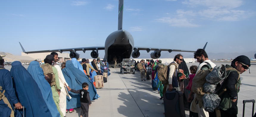 U.S. Air Force loadmasters and pilots load passengers aboard a U.S. Air Force C-17 Globemaster III in support of the Afghanistan evacuation at Hamid Karzai International Airport, Afghanistan, Aug. 24, 2021.