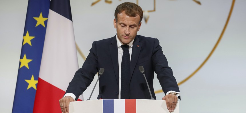 French President Emmanuel Macron pauses as he delivers a speech during a meeting in memory of the Algerians who fought alongside French colonial forces in Algeria's war, known as Harkis, at the Elysee Palace in Paris, Sept. 20, 2021. 