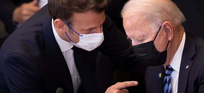 France's President Emmanuel Macron (L) talks to US President Joe Biden before a meeting of the North Atlantic Council at the North Atlantic Treaty Organization (NATO) headquarters in Brussels on June 14, 2021. 