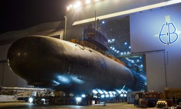 The Virginia-class attack submarine North Dakota (SSN 784) is rolled out of an indoor shipyard facility at General Dynamics Electric Boat in Groton, Connecticut.