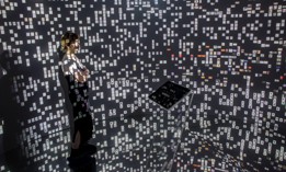 A woman views historical documents and photographs displayed in a high tech art installation at Salt Galata on May 6, 2017 in Istanbul, Turkey.