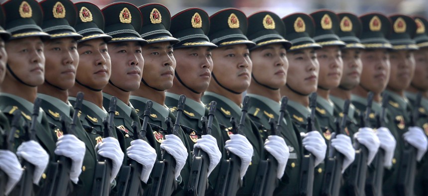 In this Oct. 1, 2019, photo, Chinese People's Liberation Army (PLA) soldiers march in formation during a parade to commemorate the 70th anniversary of the founding of the People's Republic of China in Beijing. 