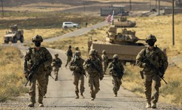 U.S. soldiers make their way to a oil production facility to meet with its management team, in Syria, Oct. 27, 2020. 