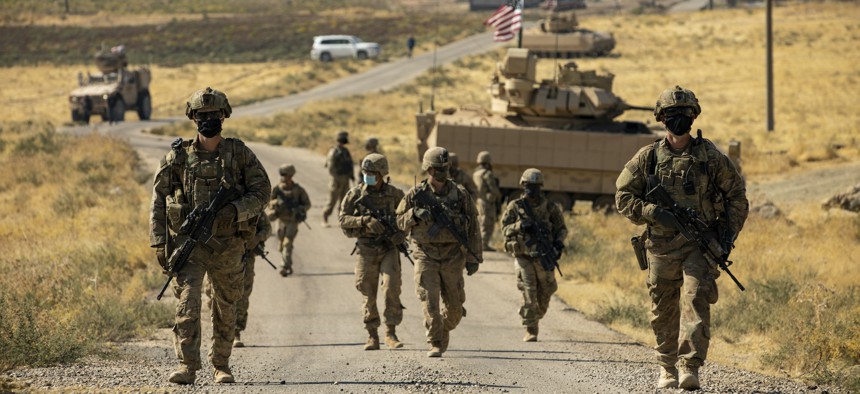 U.S. soldiers make their way to a oil production facility to meet with its management team, in Syria, Oct. 27, 2020.