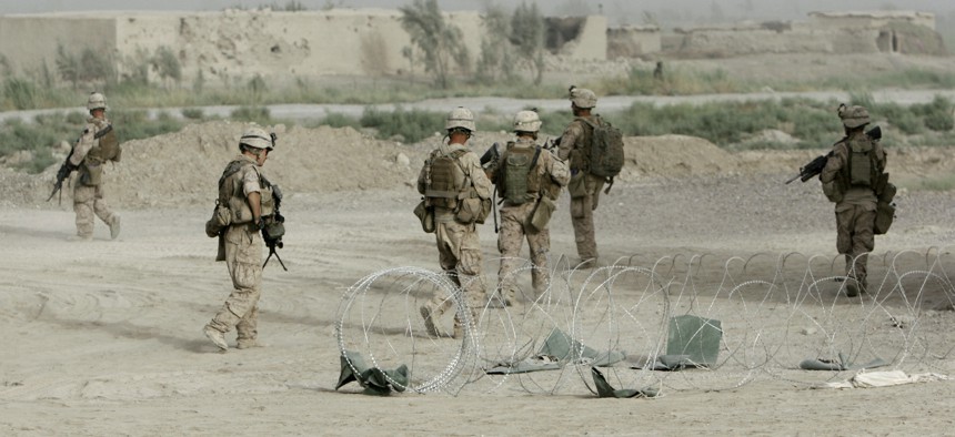 Marines from Bravo Company, Battalion Landing Team 1st Battalion, 6th Marine Regiment, 24th Marine Expeditionary Unit, patrol through a city in Helmand province, Afghanistan, in June 2008.