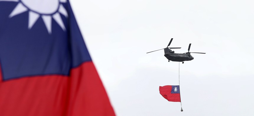 Helicopters fly with the Taiwan national flag during the National Day celebrations in Taipei, Taiwan, Oct. 10, 2020.