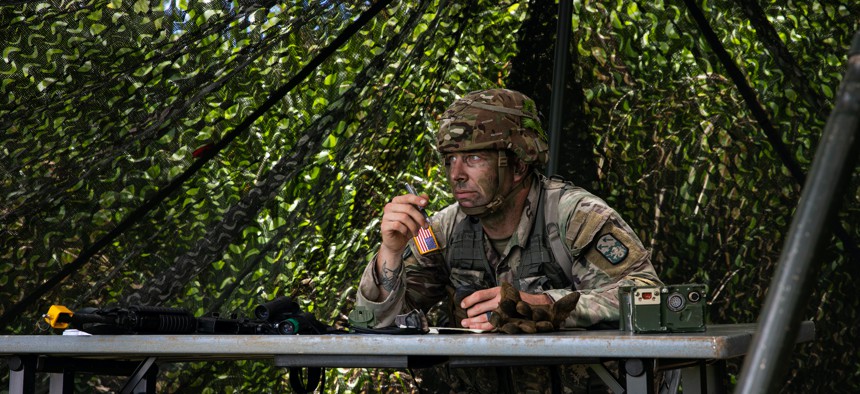 Staff Sgt. Jason Rader, a cyber network defender assigned to 94th Army Air and Missile Defense Command, scans the area while plotting points on a map during a series of warrior tasks and battle drill lanes at Lightning Academy, Wahiawa, Hawaii on June 2, 2021.
