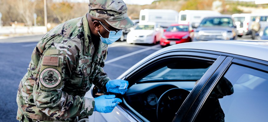 Texas Air National Guard members work a drive-through COVID-19 vaccination site March 15, 2021, at Dietert Center in Kerrville, Texas.