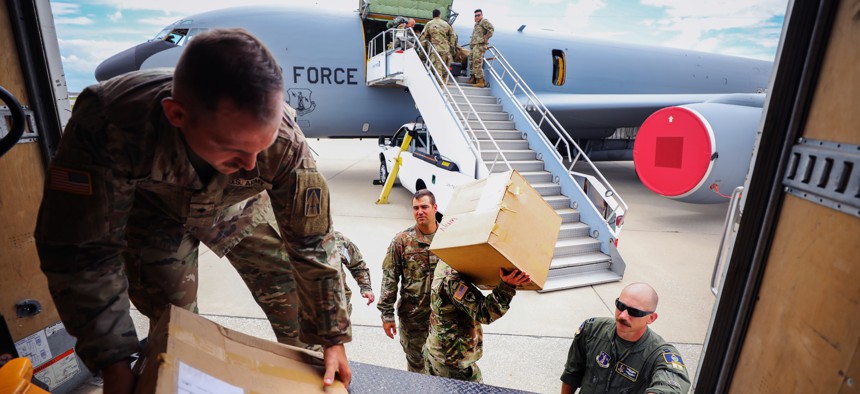 Soldiers assigned to the Indiana National Guard transport donated medical supplies to assist the country of Slovakia in its ongoing fight against COVID-19 at the Indiana National Guard Headquarters in Indianapolis, June 6, 2021.