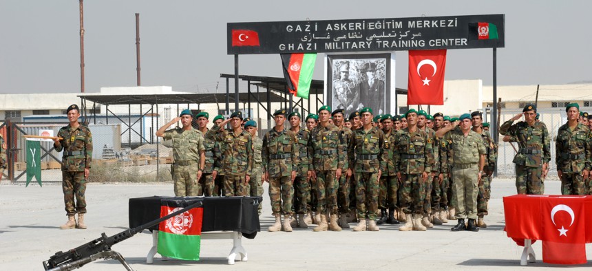 Turkey-trained Afghan non-commissioned officers salute during a graduation ceremony welcoming them into the Afghan National Army, Sept. 6, 2010. 