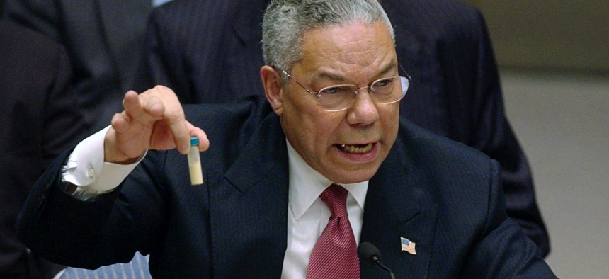 In this Feb. 5, 2003 file photo, Secretary of State Colin Powell holds up a vial he said could contain anthrax as he presents evidence of Iraq's alleged weapons programs to the United Nations Security Council.