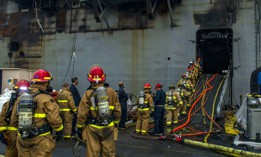 Sailors prepare to board the amphibious assault ship USS Bonhomme Richard (LHD 6) at Naval Base San Diego, July 14, 2020, to support firefighting efforts.