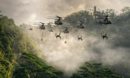 The Lockheed Martin Sikorsky RAIDER X (in the back) provides overwatch for the Lockheed Martin Sikorsky-Boeing DEFIANT X in this rendering of a M-777 artillery external lift mission.