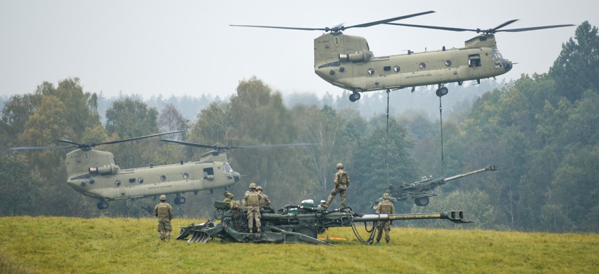 U.S. Soldiers with Field Artillery Squadron, 2nd Cavalry Regiment, conduct sling load training with the support of CH-47 Chinook helicopters, assigned to 1st Combat Aviation Brigade, 1st Infantry Division, at the 7th Army Training Command's Grafenwoehr Training Area, Germany, Oct. 19, 2021.
