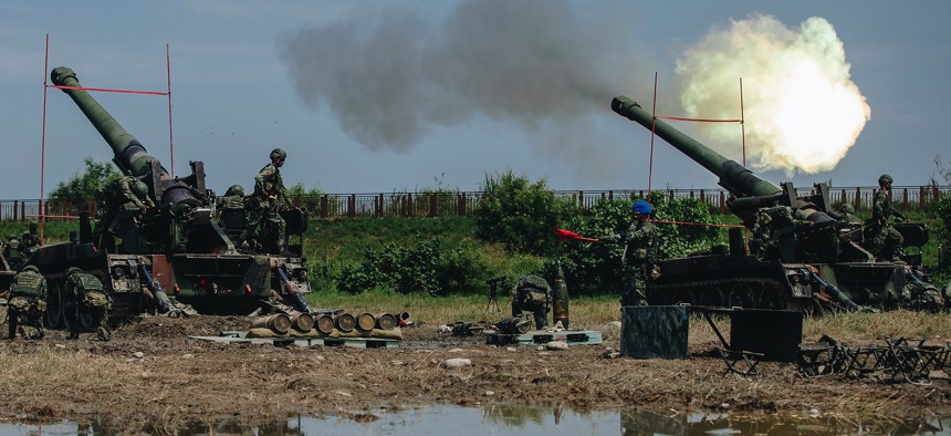 In this photo released by the Taiwan Military News Agency, Taiwanese artillery guns fire live round during the Han Guang exercises held in Taichung, Taiwan, on Thursday, Sept. 16, 2021.