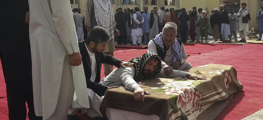 Relatives and residents attend a funeral ceremony for victims of an Islamic State suicide attack at the Gozar-e-Sayed Abad Mosque in Kunduz, northern Afghanistan, Oct. 9, 2021. 