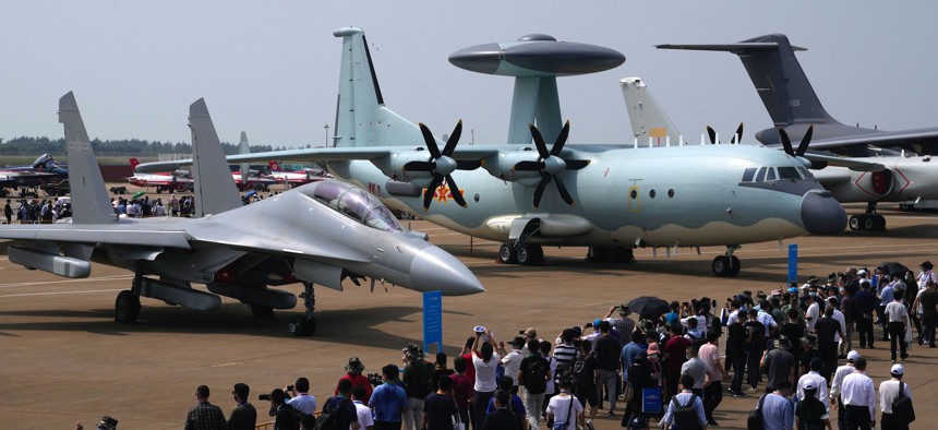 Visitors view the Chinese military's J-16D electronic warfare airplane, left, and the KJ-500 airborne early warning and control aircraft at right at Airshow China 2021 on Sept. 29, 2021, in Zhuhai in southern China's Guangdong province.