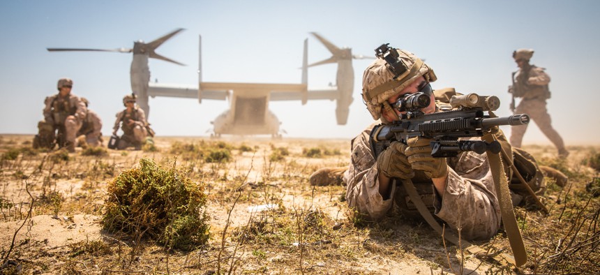 A Marine assigned to the Special Purpose Marine Air-Ground Task Force-Crisis Response-Central Command 19.2 posts security during a tactical recovery of aircraft and personnel exercise on Karan Island, Kingdom of Saudi Arabia, April 23, 2020.