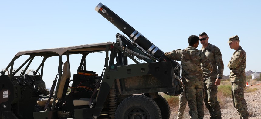U.S. Army Pfc. Ethan Loudermilk, and Pfc. Jacquavious Cook, assigned to 82nd Airborne Division, conduct checks on an Air Launched Effect (ALE) before launching it on Oct. 14, 2021, during Project Convergence 21 at Yuma Proving Ground, Arizona. 