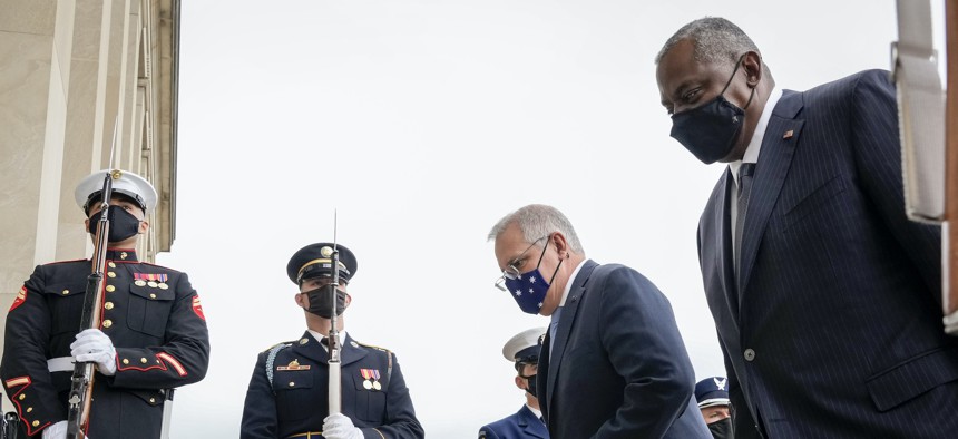 Prime Minister of Australia Scott Morrison and U.S. Secretary of Defense Lloyd Austin walk past a military honor guard as they walk inside for a meeting at the Pentagon on September 22, 2021 in Arlington, Virginia. 