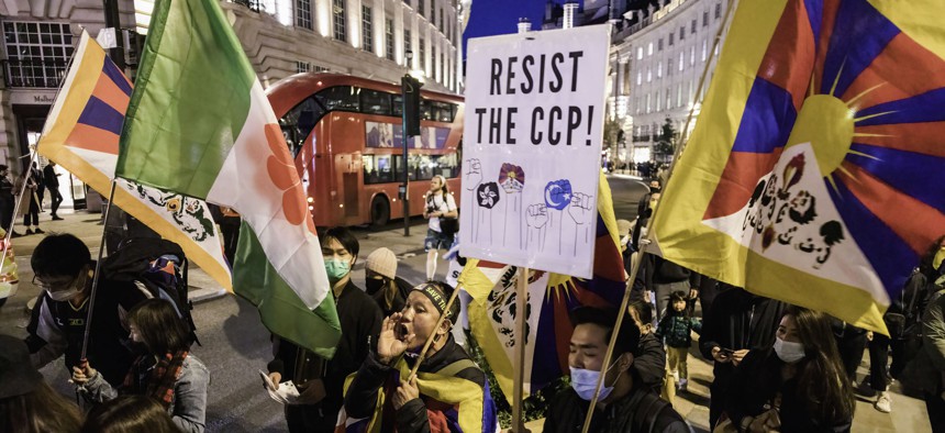 Protesters in London hold flags and placards during a demonstration against the Chinese Communist Party, Oct. 1, 2021.