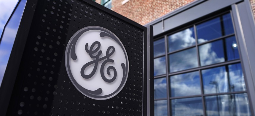 The General Electric logo is displayed on a sign outside their headquarters in Boston.