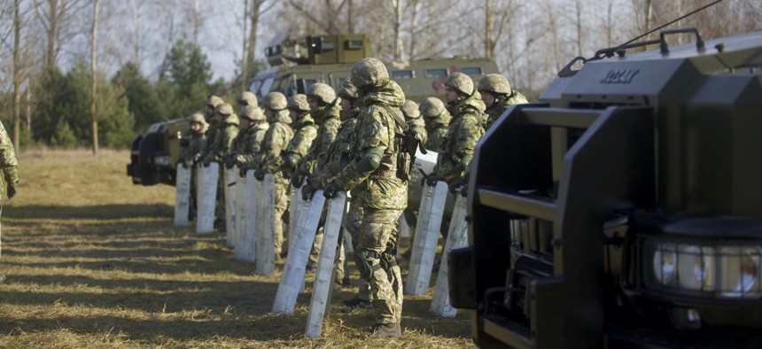 Soldiers of the Ukrainian State Border Guard Service line up at the border with Belarus in the Volyn region, Ukraine, on Thursday, Nov. 11, 2021. 