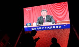 China's President Xi Jinping is seen in a big screen during an evening news program at a mall in Beijing on November 11, 2021.
