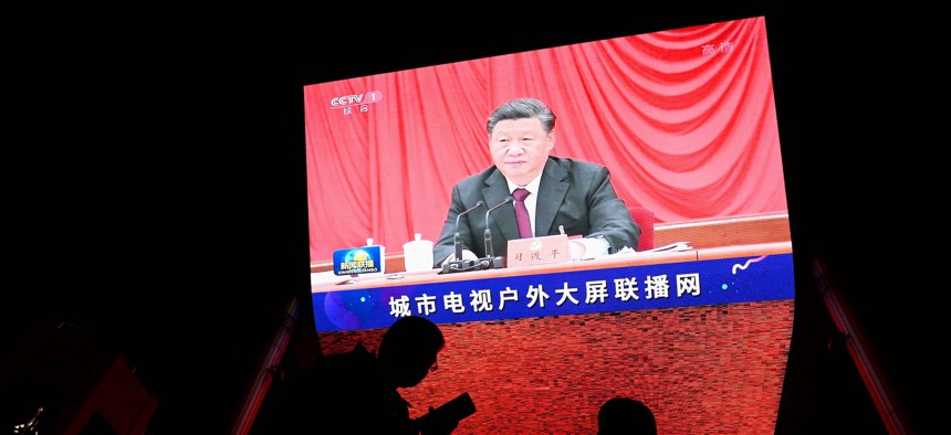 China's President Xi Jinping is seen in a big screen during an evening news program at a mall in Beijing on November 11, 2021.
