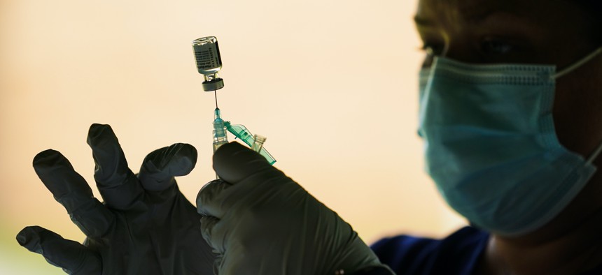 A syringe is prepared with the Pfizer COVID-19 vaccine at a clinic in Reading, Pa., on Sept. 14, 2021. 