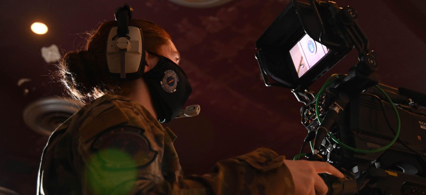 U.S. Air Force Staff Sgt. Jourdan Barrons, visual production specialist at the 2nd Audiovisual Squadron, angles her camera at the podium before show start at Hill Air Force Base on February 5, 2021.