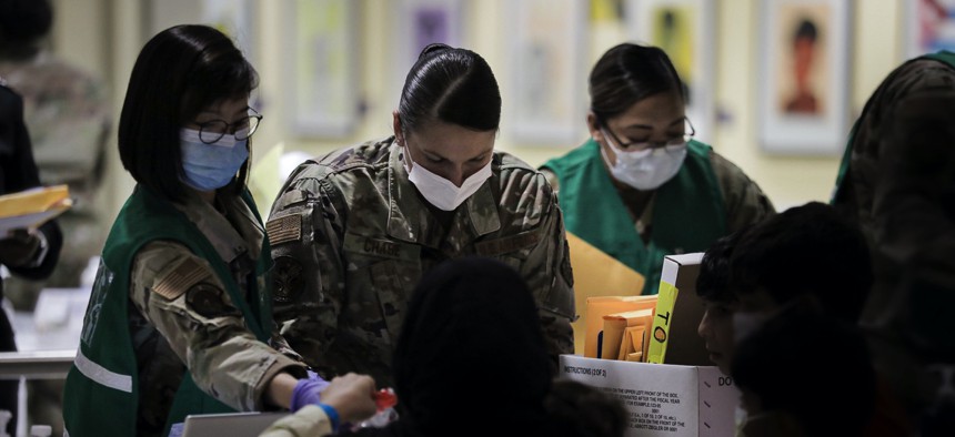 U.S. Airmen review Afghan guests’ medical paperwork at the Philadelphia International Airport, October 22, 2021. 