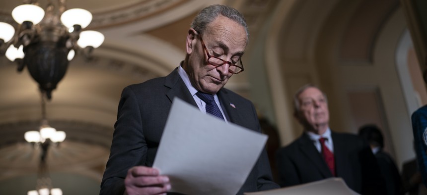 Senate Majority Leader Chuck Schumer, D-N.Y., joined at right by Majority Whip Dick Durbin, D-Ill., looks over his notes as he prepares to speak to reporters after a Democratic policy meeting at the Capitol in Washington, Tuesday, Nov. 2, 2021. 