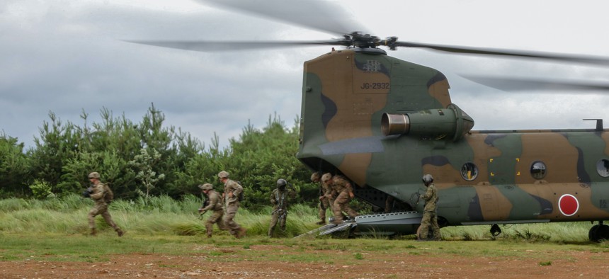 U.S. Army Soldiers assigned to 1st Battalion, 28th Infantry Regiment “Black Lions,” 3rd Infantry Division, depart from a Boeing CH-47J Chinook on Aibano Training Area, Japan, July 1, 2021, as part of exercise Orient Shield. 