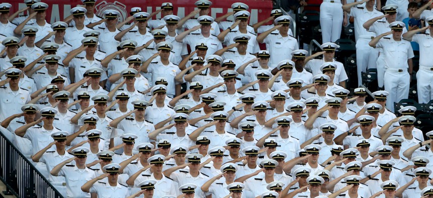 Sailors from the Merchant Marine Academy salute during the National Anthem before a baseball game at Citi Field on August 23, 2017, in New York City.