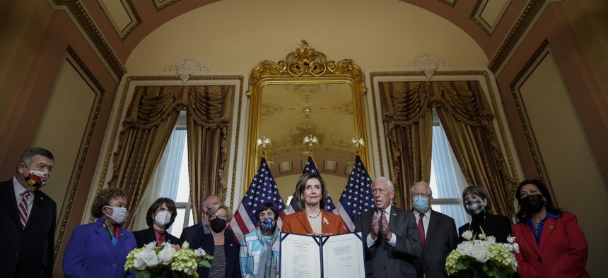 Surrounded by fellow House Democrats, Speaker of the House Nancy Pelosi (D-CA) speaks during a bill enrollment ceremony for H.R. 6119, the Further Extending Government Funding Act, at the U.S. Capitol on Dec. 3, 2021