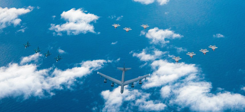 Four Japanese Air Self Defense Force F-2s (left), one B-52H Stratofortress (middle), four U.S. Air Force F-35A Lightning IIs (right), and three U.S. Air Force F-35A Lightning IIs (back) fly in formation during Operation Iron Dagger, Dec. 9, 2021. 