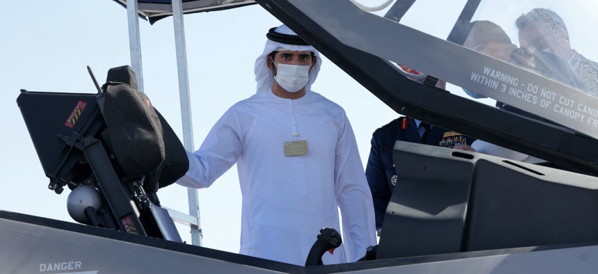 Sheikh Hamdan bin Mohammed bin Rashid Al-Maktoum, Crown Prince of Dubai, inspects the open cockpit of an F-35 Lightning II multirole combat aircraft during the 2021 Dubai Airshow in the Gulf emirate on November 14, 2021.