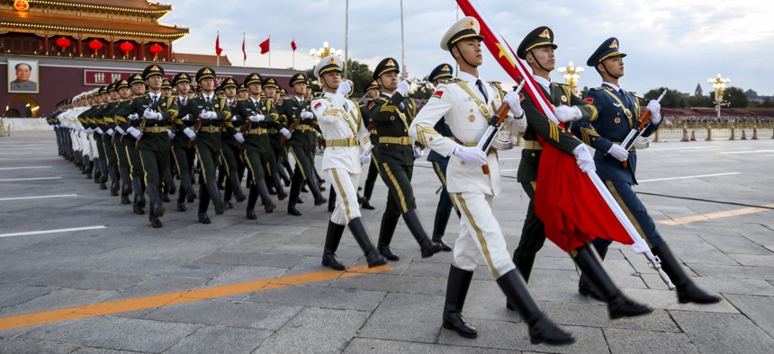The Guard of Honor of the Chinese People's Liberation Army (PLA) escort the national flag during a flag-raising ceremony at the Tian'anmen Square to mark the 72nd anniversary of the founding of the People's Republic of China on Oct. 1, 2021 in Beijing, China.