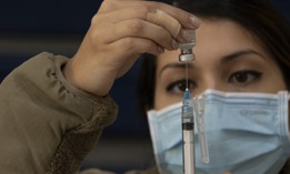 An airman prepares a syringe before administering a COVID-19 vaccination at Barksdale Air Force Base, La., Nov. 7, 2021.